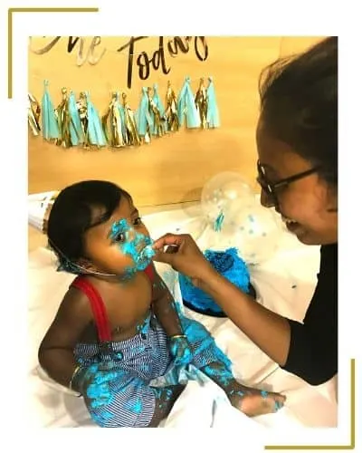 diy cake smash at home.mom feeding baby son with cake on face