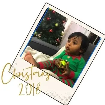 toddler boy holding Christmas ornament