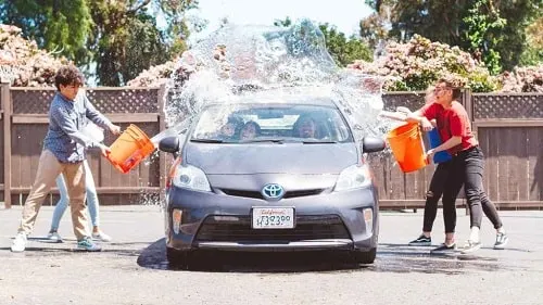 family washing car for mom