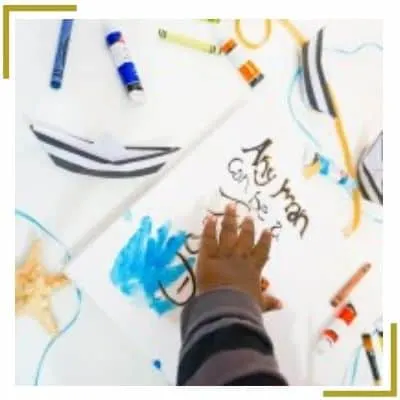 toddler making hand print craft with paint