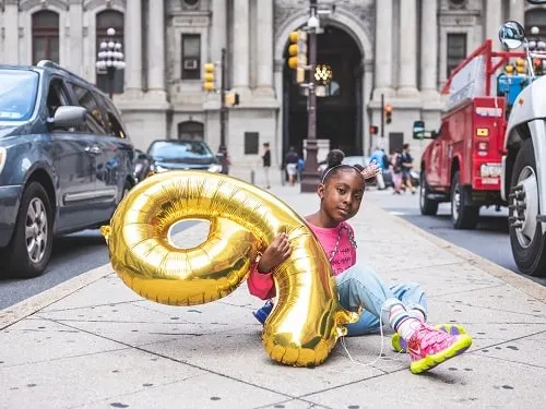 birthday girl holding helium balloon