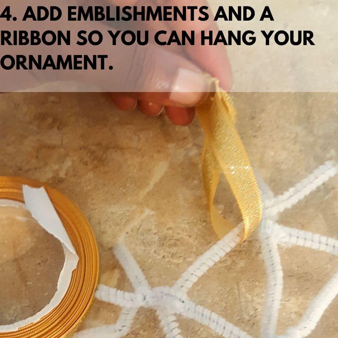 Tying a ribbon around DIY ornament craft.