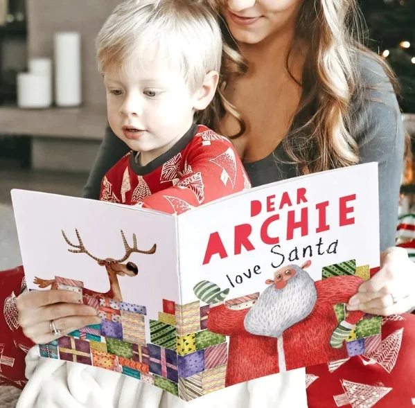 little boy reading his personalized Christmas book