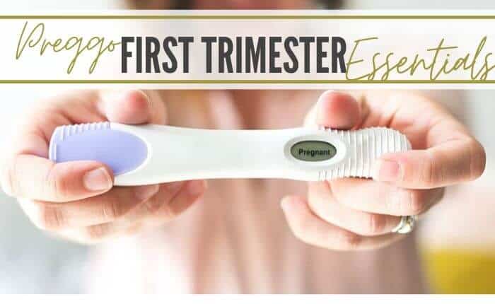 woman showing positive pregnancy test for first trimester