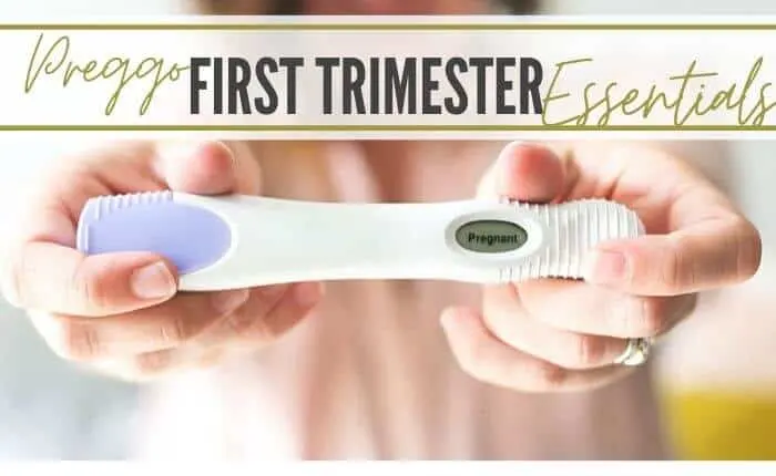 woman showing positive pregnancy test for first trimester