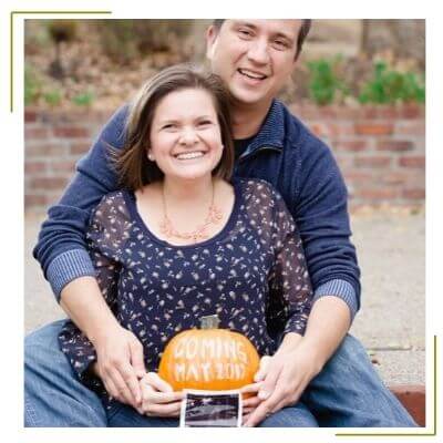 pregnant mom holding pumpkin to announce pregnancy