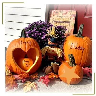 carved pumpkin of family to show pregnancy announcement 