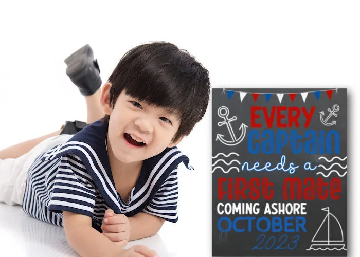 little boy dressed like sailor next to nautical pregnancy announcement