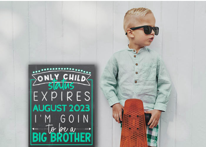 cute little boy in sun glasses holding skateboard next to sign 'only child status expiring'