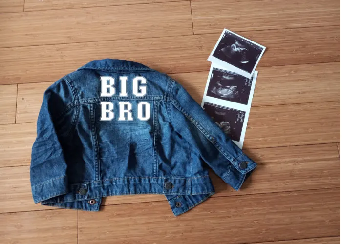 big brother sibling announcement jean jacket and sonogram pictures