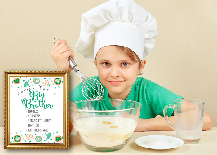 little boy baking with framed sign recipe for a big brother pregnancy announcement 