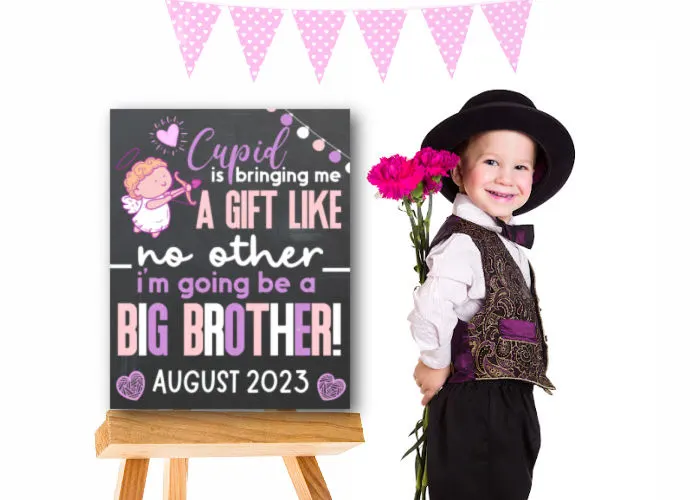 little boy holding flowers next to Valentine's Day big brother announcement 