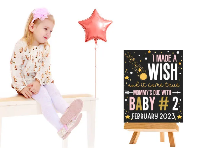 little girl sitting on table next to big sister announcement printable 