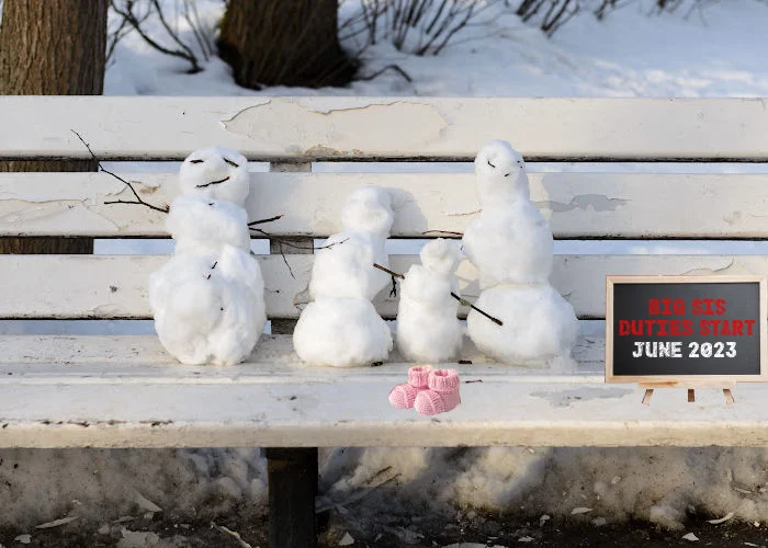 snowman family Christmas pregnancy announcement with 4 snowmen  