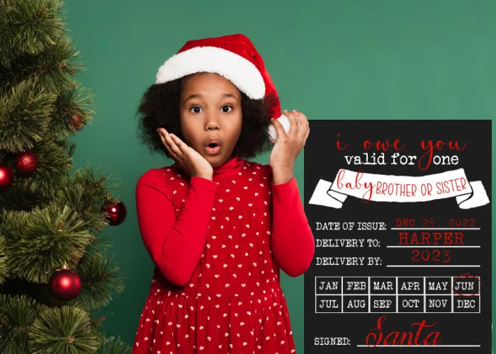 little girl wearing Santa hat with surprised face standing next to Santa I Owe You Christmas pregnancy announcement with sibling