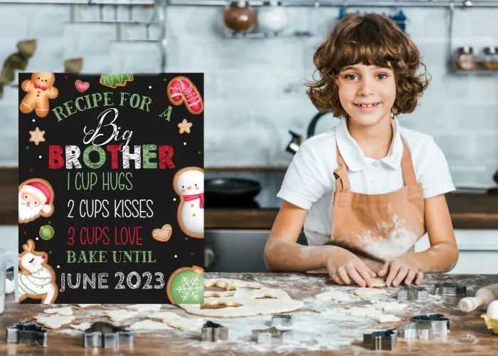 little boy baking cookies next to recipe for a big brother announcement board