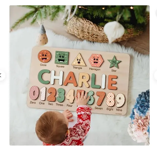 baby playing with personalized wooden name puzzle