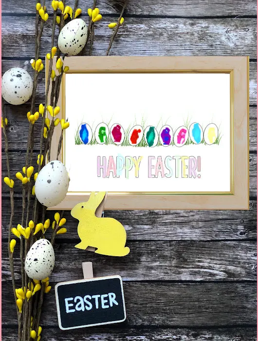 image of Easter fingerprint craft in frame with easter eggs around it