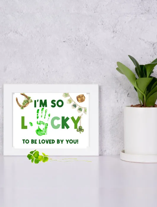 cute St. Patrick's Day handprint craft for preshool that reads I'm so lucky to be loved by you