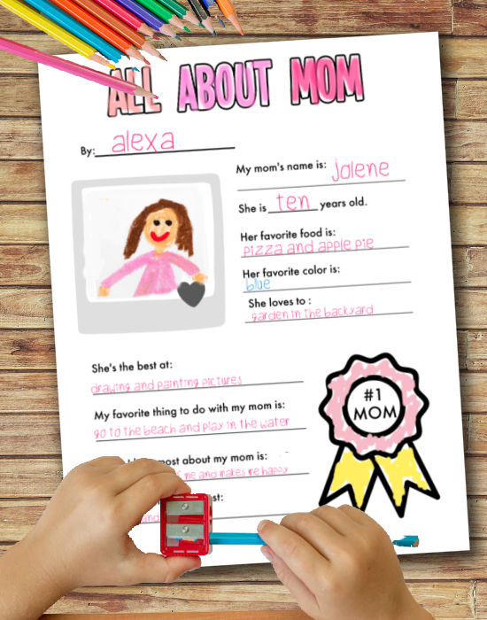 child filling out All about my mom free printable worksheet on wood table  and sharpening pencil 