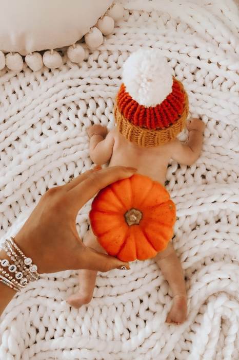 cute fall baby photo idea with mini pumpkin to cover baby butt