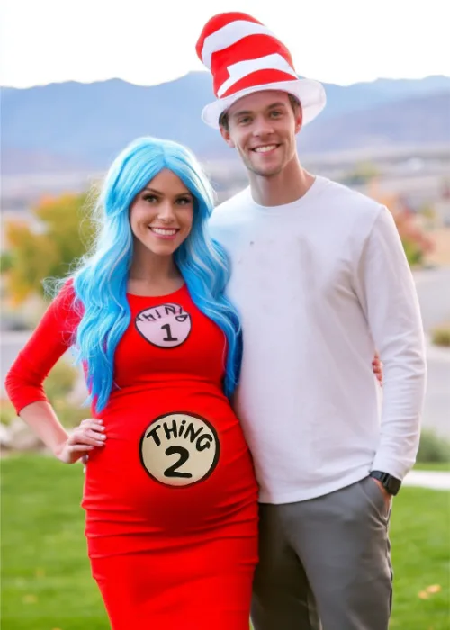 a pregnant couple is dressed in Dr.Seus Themed costumes with thing 1 and thing 2 and husband is the cat in the hat.
