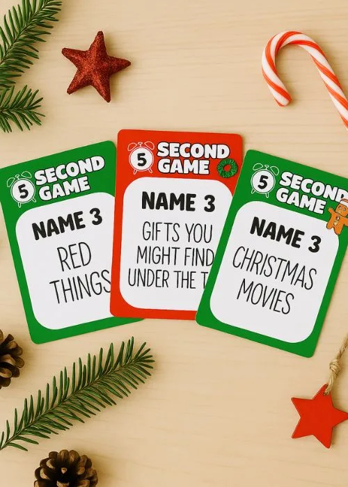 flat lay of 5 second rule game crds with evergreen branches and pine cones