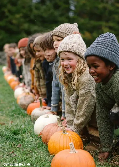 children lined up with a row of pumpkins to play fun thanksgiving party game: pumpkin relay race