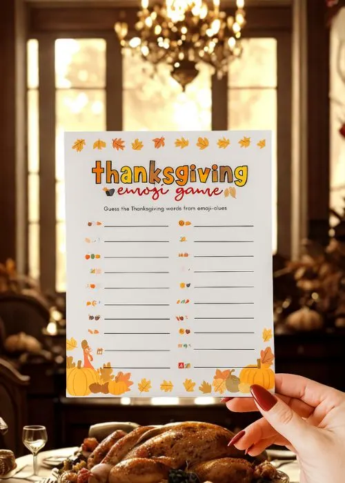easy thanksgiving party games: thanksgiving emoji game being held up at the dinner table