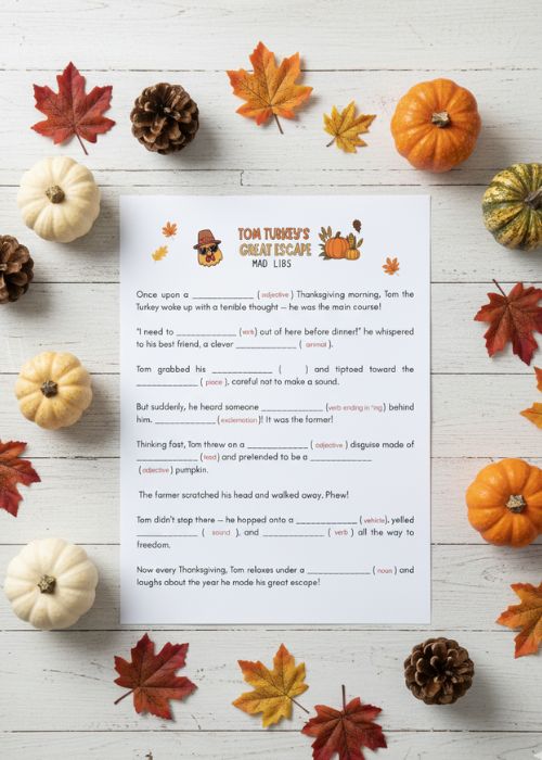 flat lay of Thanksgiving mad lib printable with pumpkins and leaves