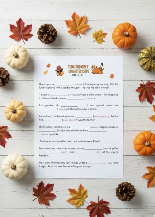 flat lay of Thanksgiving mad lib printable with pumpkins and leaves