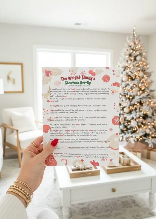 a manicured hand is holding up the Christmas left right story game in a Christmas living room