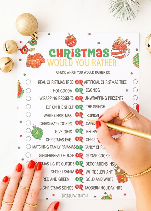 a woman's hand is filling out the Christmas This or That game