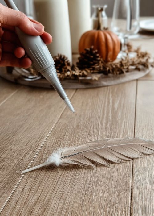 a turkey baster is being used to blow a feather into the air for a fun thanksgiving party game