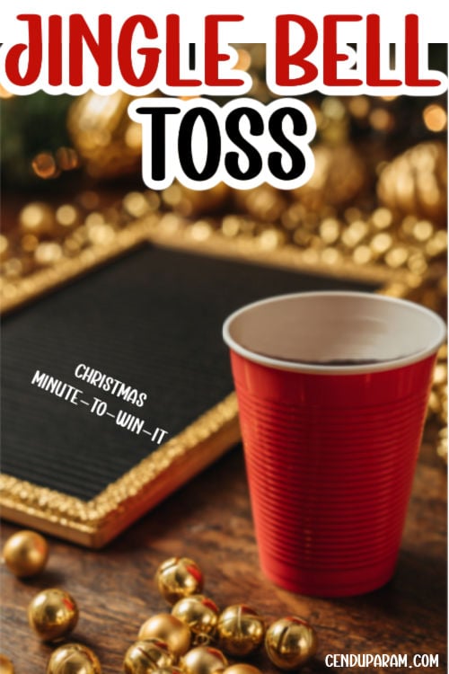 a red plastic cup is on a table with a bunch of golden jingle bells, for a festive holiday game