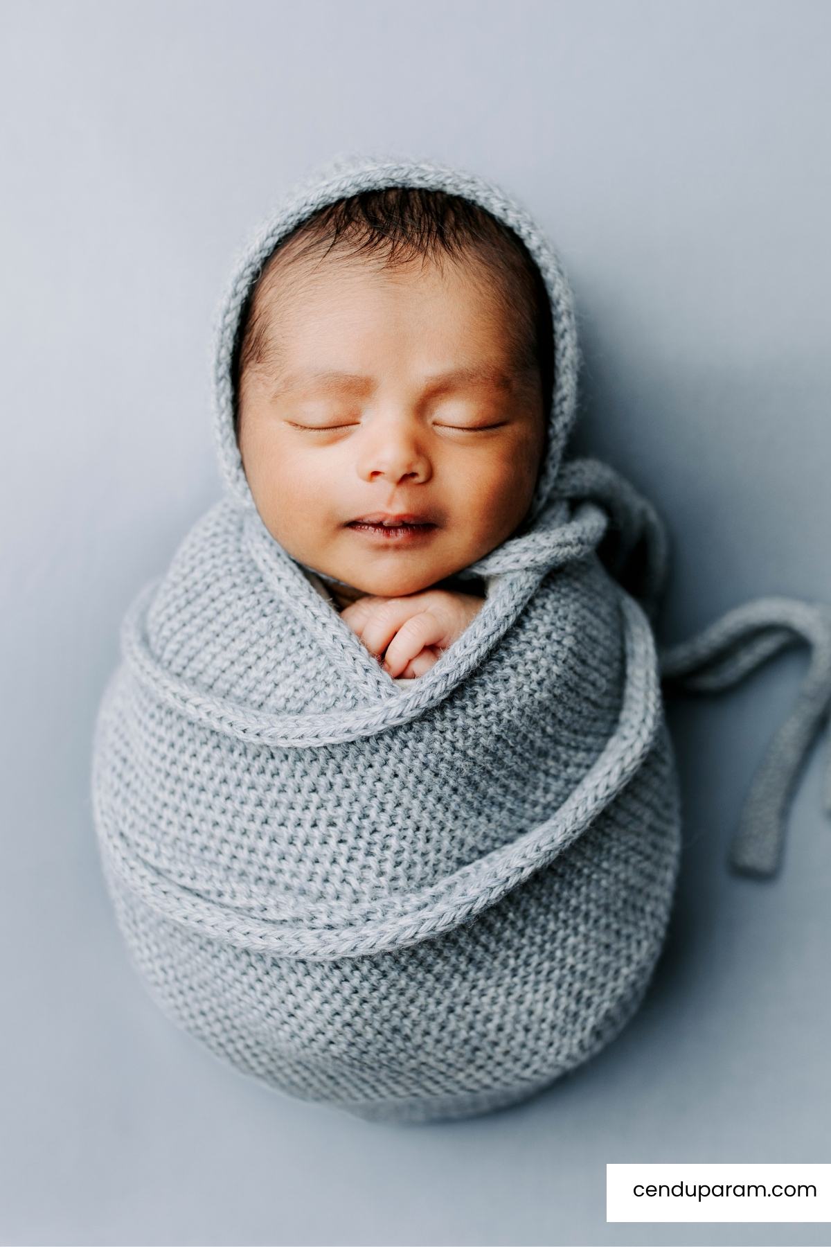 adorable newborn photography of baby boy in wrapped blue knit blanket. unique gift idea for baby shower, newborn photography session