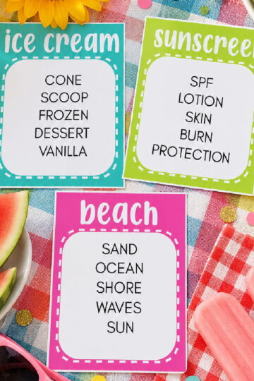 flat lay of summer taboo game cards on picnic blanket