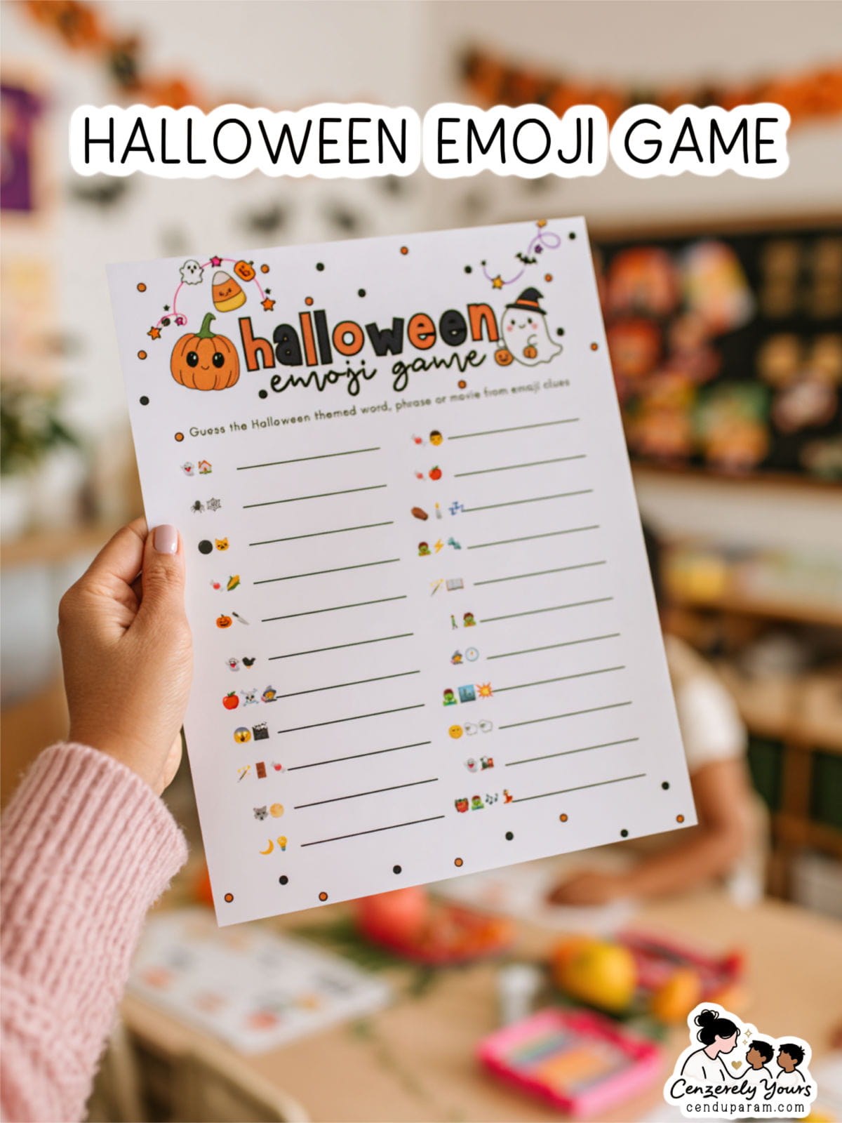 a teacher's hand holds out the Halloween Emoji game