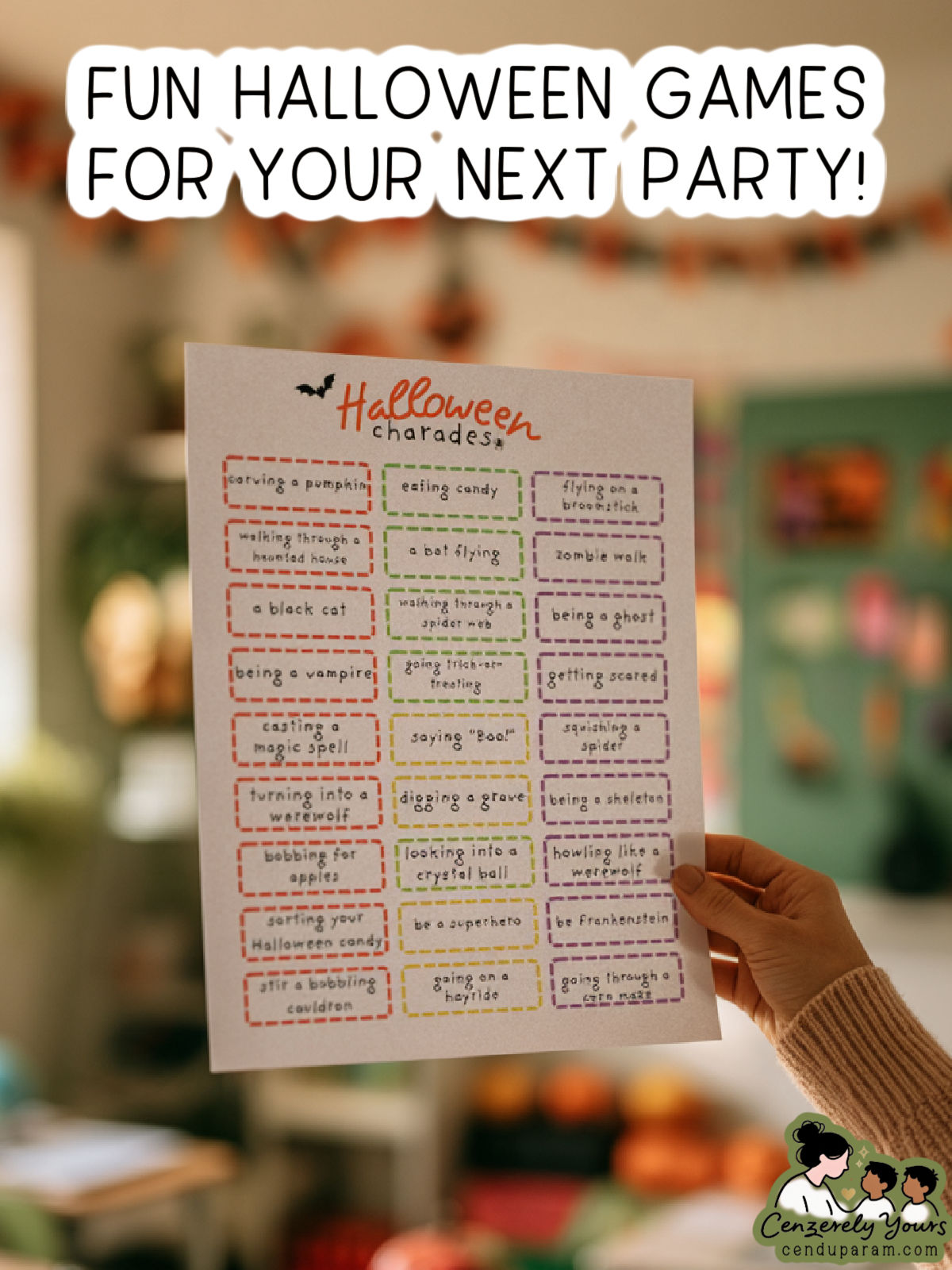 a teacher's hand holds up the Halloween charades printable game